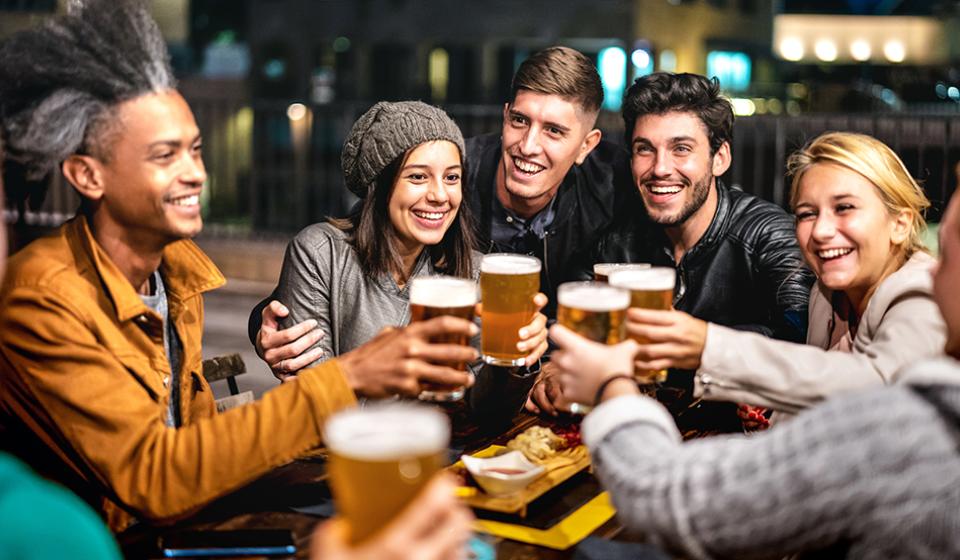 Happy friends group drinking beer at brewery bar out doors